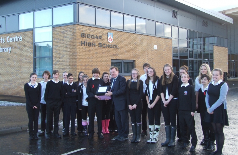 David Mundell accepts a box of petitions and letters from Biggar High students