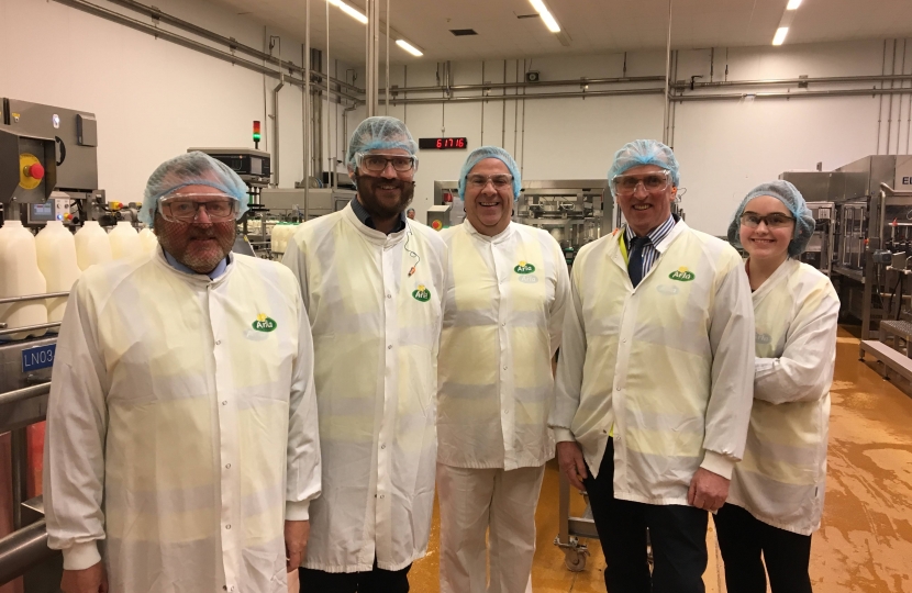 David alongside Oliver Mundell and staff at the Arla factory