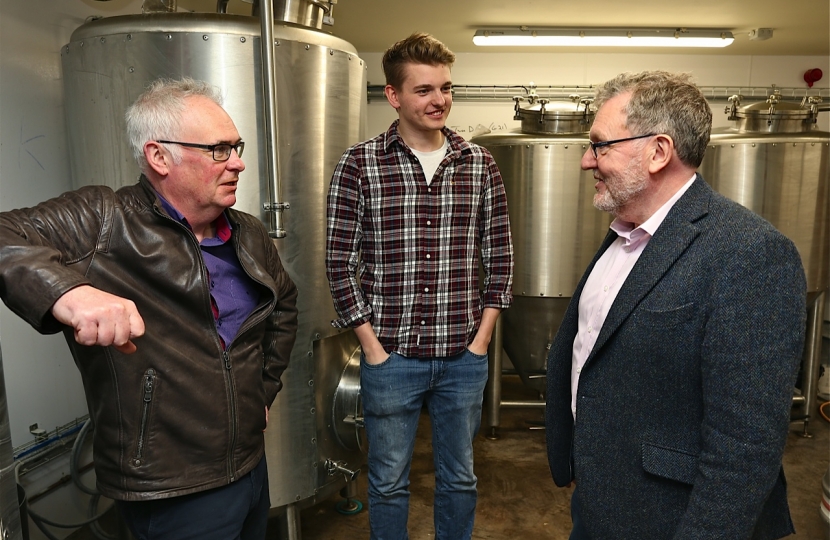 David Mundell MP, managing director Michael Tough and head brewer Tom Barr Lowland Brewery's 'Twa Dugs'
