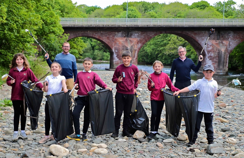 SUMMER CLEAN-UP . . . collecting litter on the banks of the River Esk this week were pupils from Canonbie Primary School and local MSP Oliver Mundell, back, left, and MP David Mundell The pupils, front, left to right, are: Danielle Ward, Maisie Hay, Daniel Stevens, Jayden McVittie, Grace Ellwood and Campbell Graham