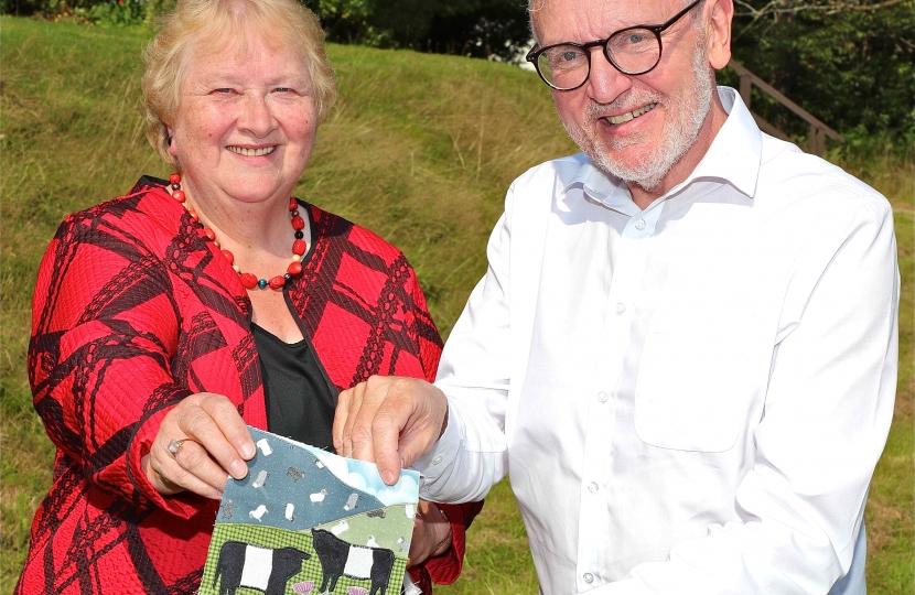 CRAFTWORK . . . Ann Hill hands over the Dumfriesshire, Clydesdale and Tweeddale square for the Parliamentary Covid Memorial Quilt to constituency MP David Mundell