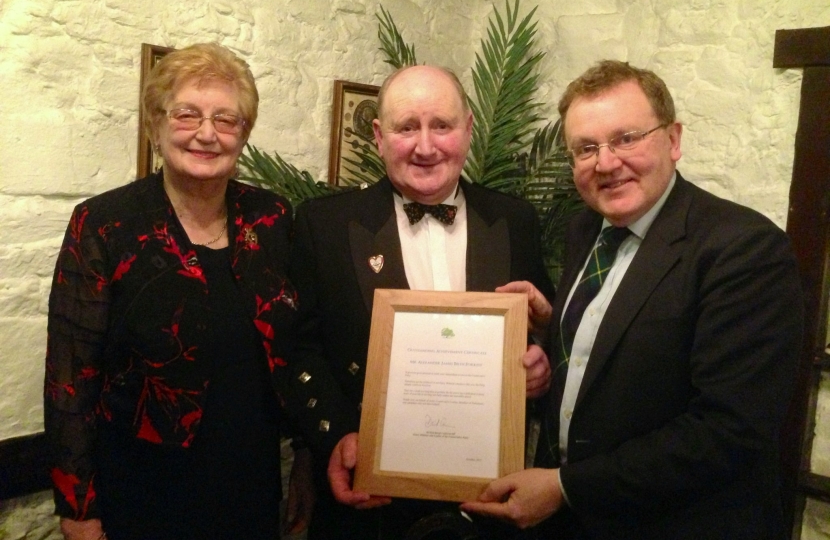 David pictured presenting the letter to Beith (centre) and his wife Morag