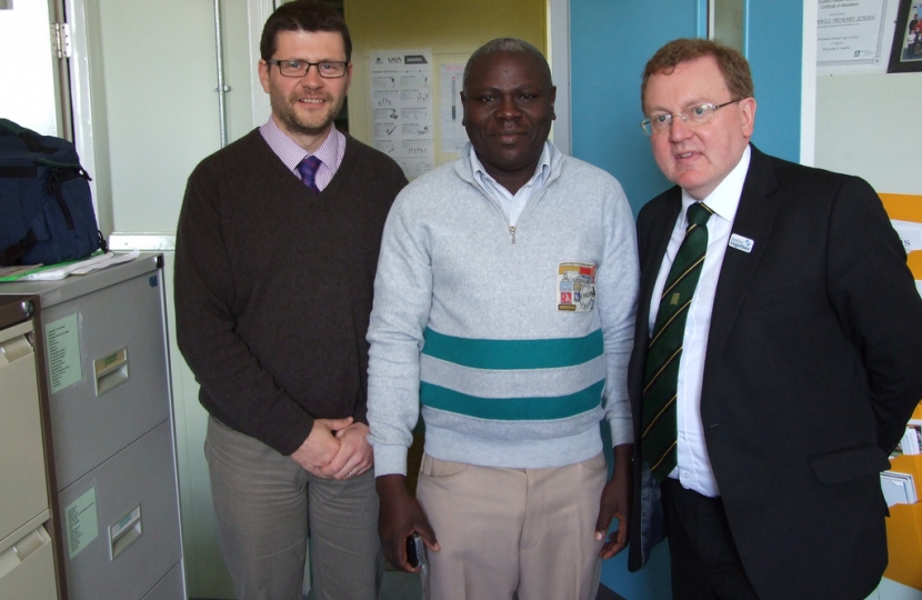 David Mundell with head teacher Martin Armstrong and George Odhiambo at Nethermi