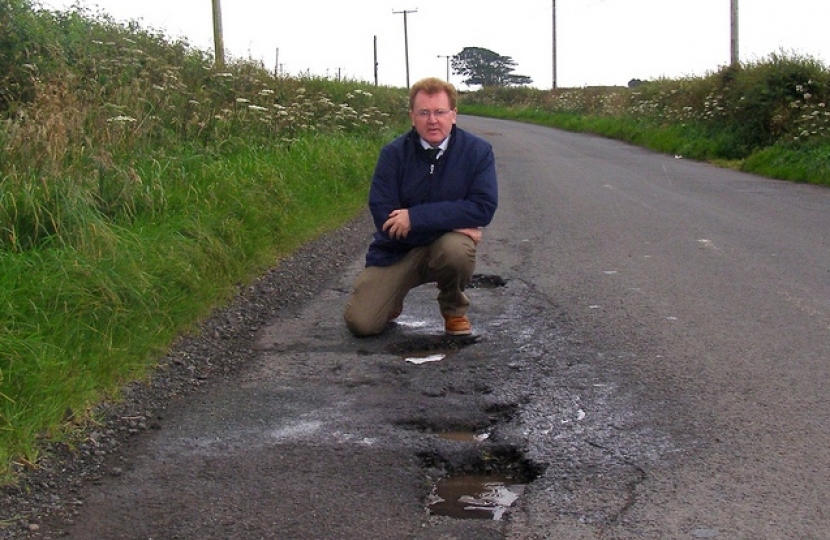David Mundell inspecting potholes
