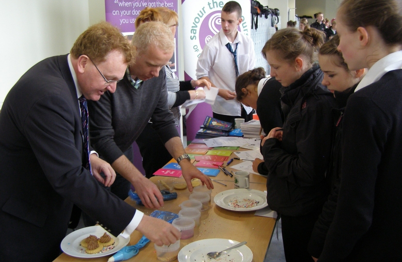 David Mundell ices biscuits with students and Ruessell Pearce, Brodie's Moffat