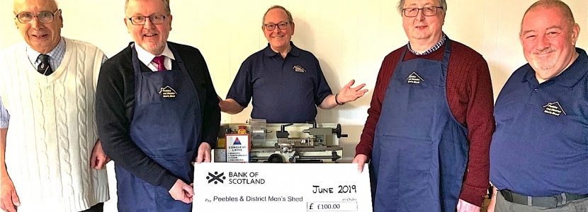 SHED BOOST . . . Tweeddale MP David Mundell, second from left, presents a cheque to Peebles and District Men's Shed team members, left to right: Tony Butcher, Les Silk, Iain Coates and Malcolm Bruce 