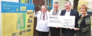 Dumfriesshire, Clydesdale and Tweeddale MP David Mundell, third from left, presents a cheque to project team members, left to right: Ina Pufkji, chairwoman; Stefan Danczak and Mary (Mychalyschyn) MacRae, treasurer.