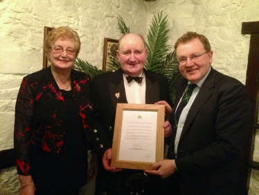 David pictured presenting the letter to Beith (centre) and his wife Morag