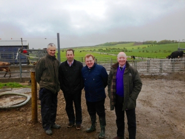 David Mundell is pictured with farmers during a fact finding visit to a local fa