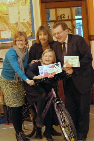 David presents the cycle to Lauren with Cllr Gill Dykes and Lauren's mum Jan