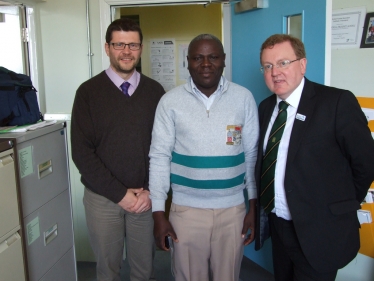 David Mundell with head teacher Martin Armstrong and George Odhiambo at Nethermi